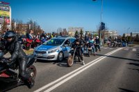 Fotografia kolorowa. Przedstawia uczestników przejazdu motocyklowego oraz policjantów zabezpieczających to wydarzenie.